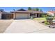 Well-kept single-story home with a spacious driveway and a two-car garage at 3009 W Christy Dr, Phoenix, AZ 85029