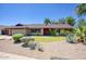 Charming single-story brick home with well-maintained landscaping and desert accents at 3009 W Christy Dr, Phoenix, AZ 85029