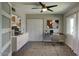 Bright home office featuring a modern desk, stylish decor, and a ceiling fan for added comfort at 3009 W Christy Dr, Phoenix, AZ 85029