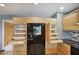 Kitchen pantry with pull-out shelves and a large black refrigerator for convenient storage at 3009 W Christy Dr, Phoenix, AZ 85029