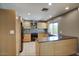Modern kitchen featuring sleek wood cabinets, black appliances, and a gray backsplash at 3009 W Christy Dr, Phoenix, AZ 85029