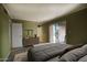 Comfortable main bedroom with a neutral color scheme, plush bedding, and access to the outdoor patio at 3009 W Christy Dr, Phoenix, AZ 85029
