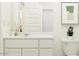 Cozy bathroom featuring white cabinets, a sleek mirror, a toilet, and an art piece at 3139 E Barrel Race Rd, San Tan Valley, AZ 85140