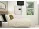 Cozy bedroom featuring a bed with pillows, neutral walls, a window, and a stylish mirror at 3139 E Barrel Race Rd, San Tan Valley, AZ 85140