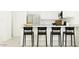 Modern kitchen bar area featuring sleek black chairs, white cabinets, and ample counter space at 3139 E Barrel Race Rd, San Tan Valley, AZ 85140
