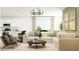 Stylish living room featuring a comfortable sectional sofa, a modern decor, and ample natural light at 3139 E Barrel Race Rd, San Tan Valley, AZ 85140