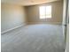 Spacious bedroom with large window providing abundant natural light and modern carpet at 31878 N Bandit Rd, San Tan Valley, AZ 85143