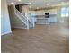Spacious open floor plan features new wood-look flooring, stairs, and kitchen with a center island at 31878 N Bandit Rd, San Tan Valley, AZ 85143