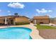 Resort style backyard with a large pool, complemented with desert landscaping and a shed at 4556 W Cholla St, Glendale, AZ 85304