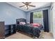 Bedroom with a black bed, a ceiling fan, and curtains at 4556 W Cholla St, Glendale, AZ 85304