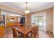 Bright dining room connecting to the kitchen, perfect for Gathering meals, and featuring a view of the pool at 4556 W Cholla St, Glendale, AZ 85304