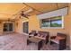 Covered patio offers a relaxing outdoor space with comfortable seating and ceiling fans for cooling at 4556 W Cholla St, Glendale, AZ 85304