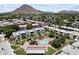 Aerial view showcasing community pool, manicured lawns, and the surrounding neighborhood with mountain views at 4610 N 68Th St # 411, Scottsdale, AZ 85251