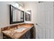 Bathroom featuring marble countertop, modern sink and fixtures, a dark wood cabinet and an elegant mirror at 4610 N 68Th St # 411, Scottsdale, AZ 85251