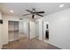 Spacious bedroom with neutral carpet, lighted ceiling fan, closet, and access to the bathroom at 4610 N 68Th St # 411, Scottsdale, AZ 85251