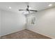Bedroom featuring neutral carpet, a ceiling fan, and a window with plantation shutters at 4610 N 68Th St # 411, Scottsdale, AZ 85251