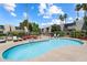 Community pool area with lounge chairs, desert landscaping, and well-maintained shrubbery at 4610 N 68Th St # 411, Scottsdale, AZ 85251