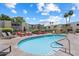 Community pool area with lounge chairs, desert landscaping, and lush shrubbery at 4610 N 68Th St # 411, Scottsdale, AZ 85251