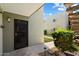 Charming front door entrance with security screen and well-maintained landscaping at 4610 N 68Th St # 411, Scottsdale, AZ 85251