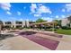 Exterior view of community shuffleboard courts and seating area, surrounded by lush landscaping at 4610 N 68Th St # 411, Scottsdale, AZ 85251