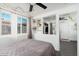 Sunlit bedroom showcases a ceiling fan, storage shelves, closet and natural lighting at 4629 N 9Th St, Phoenix, AZ 85014
