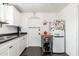 Efficient kitchen boasts white cabinets, stainless steel sink, dark counters and modern appliances at 4629 N 9Th St, Phoenix, AZ 85014
