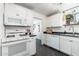 Functional kitchen with white appliances, black countertops, and ample cabinet space at 4629 N 9Th St, Phoenix, AZ 85014