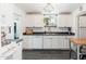 Bright kitchen with white cabinets, black countertops, and stainless steel appliances at 4629 N 9Th St, Phoenix, AZ 85014
