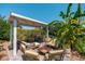 Inviting covered patio with stylish furniture and a cozy fire pit, surrounded by beautiful greenery and blue sky at 4629 N 9Th St, Phoenix, AZ 85014