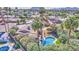 An aerial view of lush tropical landscape, a pool, a large yard, mountain views and neighborhood at 5119 N 87Th St, Scottsdale, AZ 85250