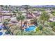 An aerial view showcasing a pool in the backyard with a patio, lush landscaping, and mountain views at 5119 N 87Th St, Scottsdale, AZ 85250