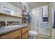 Modest bathroom featuring a shower, toilet, single sink vanity and mirrored medicine cabinet at 5119 N 87Th St, Scottsdale, AZ 85250