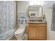 Cozy bathroom featuring a shower-tub, toilet, single sink vanity, and medicine cabinet at 5119 N 87Th St, Scottsdale, AZ 85250