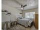 Bedroom with neutral walls, a ceiling fan, closet, tile flooring and a queen bed at 5119 N 87Th St, Scottsdale, AZ 85250