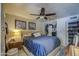 Bright bedroom featuring a queen bed, ceiling fan, closet, carpet and neutral walls at 5119 N 87Th St, Scottsdale, AZ 85250