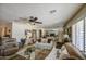 Cozy living room featuring a ceiling fan, comfortable couches, and a glass coffee table at 5119 N 87Th St, Scottsdale, AZ 85250