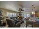 Open-concept living area showcases a ceiling fan, fireplace, plush seating, and seamless flow to the kitchen at 5119 N 87Th St, Scottsdale, AZ 85250