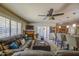 Living room with a fireplace, a ceiling fan, a comfy couch and an open view of the kitchen at 5119 N 87Th St, Scottsdale, AZ 85250