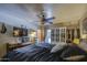 Tranquil main bedroom features a ceiling fan, built-in storage, and a cozy atmosphere for relaxation at 5119 N 87Th St, Scottsdale, AZ 85250