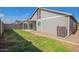 Lush backyard with fresh grass, gray exterior, and a concrete patio at 5808 S 12Th Ln, Phoenix, AZ 85041