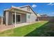 Backyard featuring green grass, gray siding, and a covered patio at 5808 S 12Th Ln, Phoenix, AZ 85041
