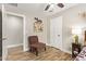 Cozy bedroom with a ceiling fan, brown chair, and themed wall decor at 5808 S 12Th Ln, Phoenix, AZ 85041