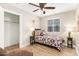 Charming bedroom featuring a cozy bed, ceiling fan, and closet, perfect for a guest room at 5808 S 12Th Ln, Phoenix, AZ 85041