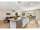 Open-concept kitchen featuring stainless steel appliances and a granite island flowing into the living space at 5808 S 12Th Ln, Phoenix, AZ 85041