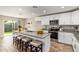 Kitchen featuring stainless appliances, granite countertops, ample seating and easy access to the dining area at 5808 S 12Th Ln, Phoenix, AZ 85041