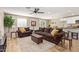 Inviting living room featuring neutral walls, tile floors, comfortable furniture, and a ceiling fan at 5808 S 12Th Ln, Phoenix, AZ 85041