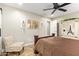 Comfortable bedroom with a ceiling fan and a decorative armoire, offering a relaxing retreat at 5808 S 12Th Ln, Phoenix, AZ 85041