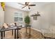Well-lit office space with a ceiling fan, desk, and neutral walls at 5808 S 12Th Ln, Phoenix, AZ 85041