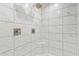 Beautifully tiled walk-in shower with a rainfall showerhead and a built-in seat for added convenience at 5808 S 12Th Ln, Phoenix, AZ 85041