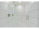 Elegant walk-in shower featuring marble-look tiles, rainfall showerhead, and glass enclosure for a spa-like experience at 5808 S 12Th Ln, Phoenix, AZ 85041